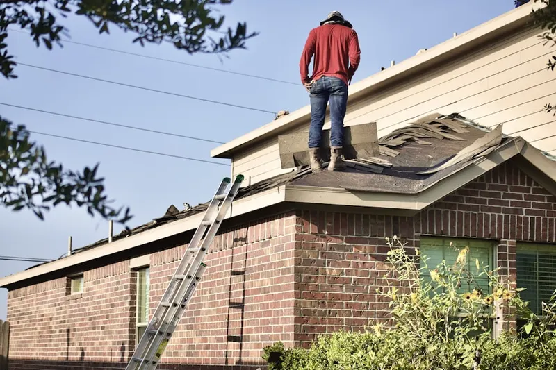 Professional roofer working on a residential roof in Suwanee